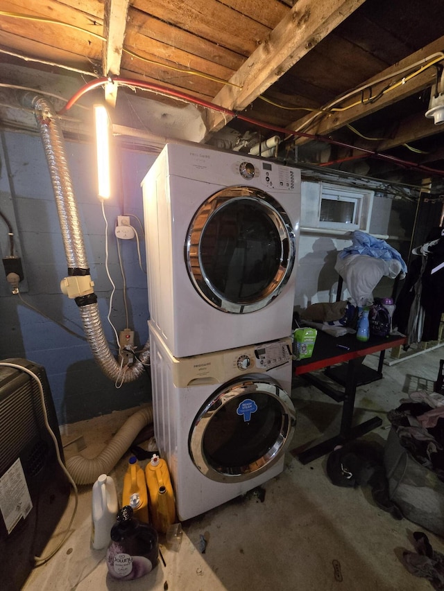 laundry area featuring stacked washer / drying machine and laundry area