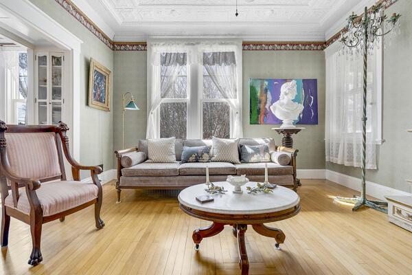 sitting room with crown molding, baseboards, and hardwood / wood-style floors