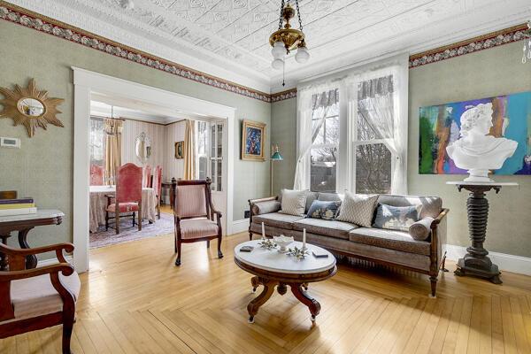 living area with baseboards and a notable chandelier