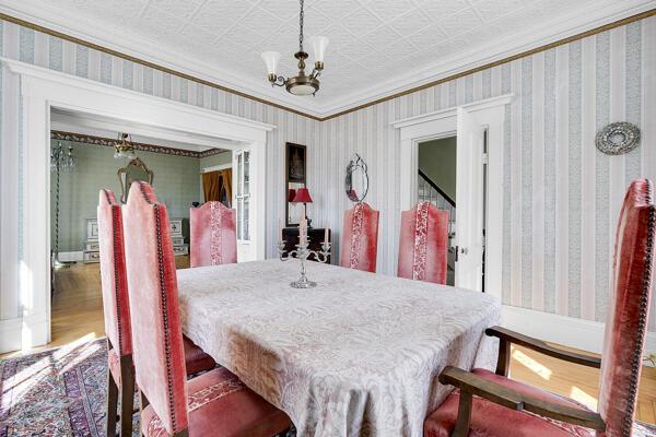 dining room featuring ornamental molding, wood finished floors, and a notable chandelier