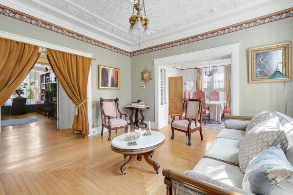 sitting room with ornamental molding, a notable chandelier, and a wealth of natural light