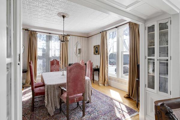 dining area featuring an inviting chandelier, plenty of natural light, and wood finished floors