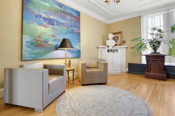 sitting room featuring wood finished floors and radiator heating unit