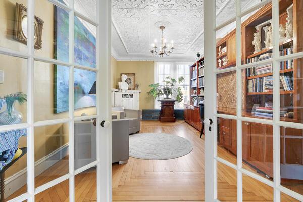 doorway to outside with an inviting chandelier, ornamental molding, and french doors