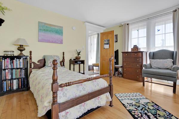 bedroom featuring multiple windows and wood finished floors