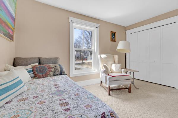 bedroom with baseboards, carpet, and a closet