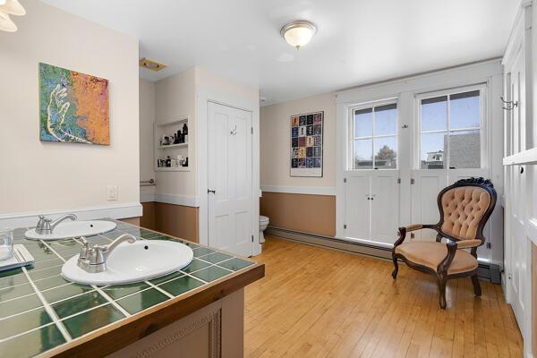bathroom with a sink, toilet, hardwood / wood-style flooring, and a baseboard heating unit