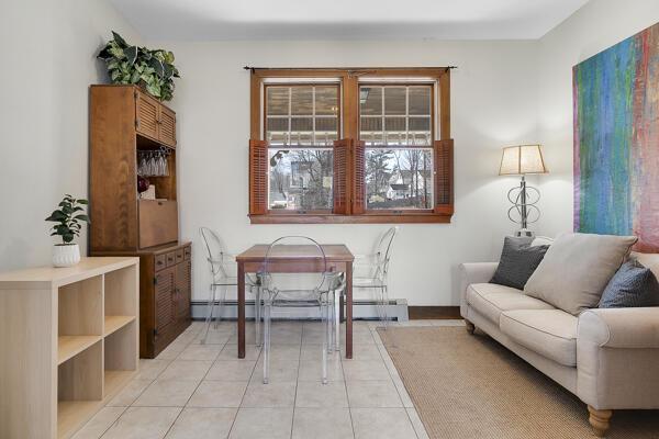 living area featuring a baseboard radiator and light tile patterned flooring