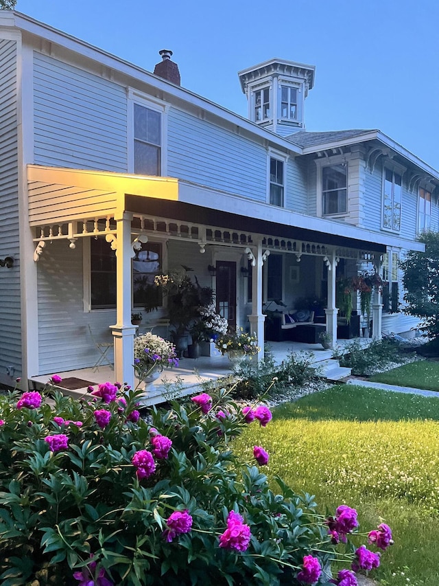 rear view of house with covered porch