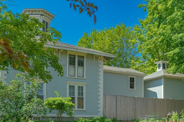 view of home's exterior featuring fence