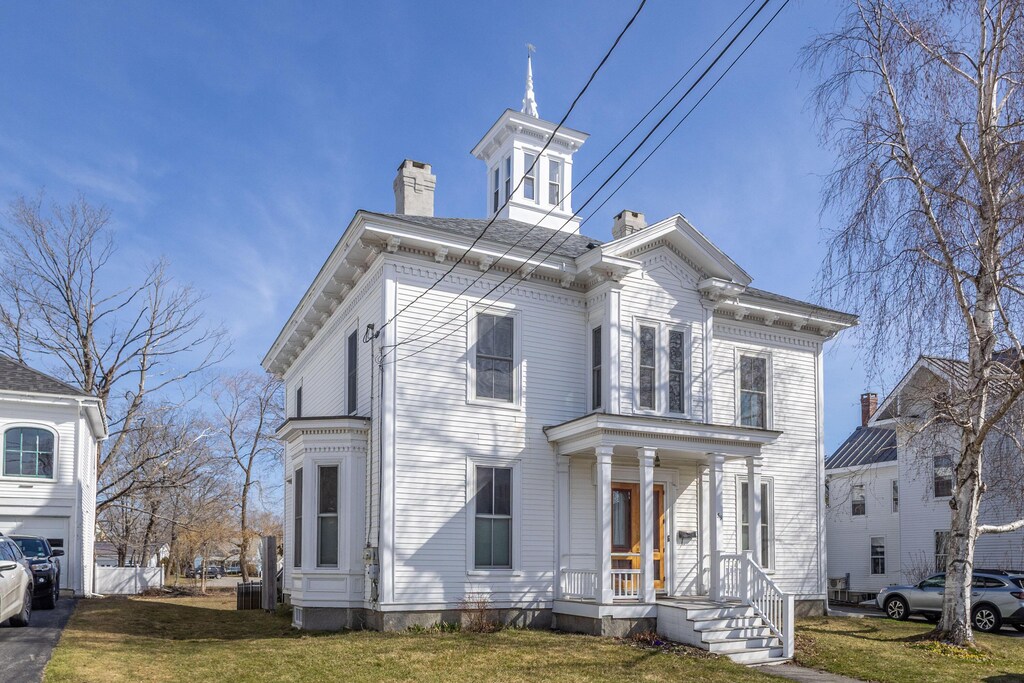 59 Masonic St, Rockland, ME 04841 - view of front of house with a chimney, fence, and a front lawn