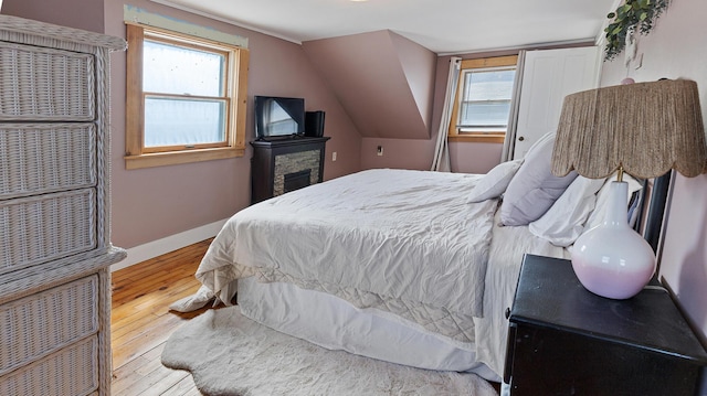 4 Burgess Rd, Guilford, ME 04443 - bedroom featuring hardwood / wood-style flooring, multiple windows, vaulted ceiling, and baseboards