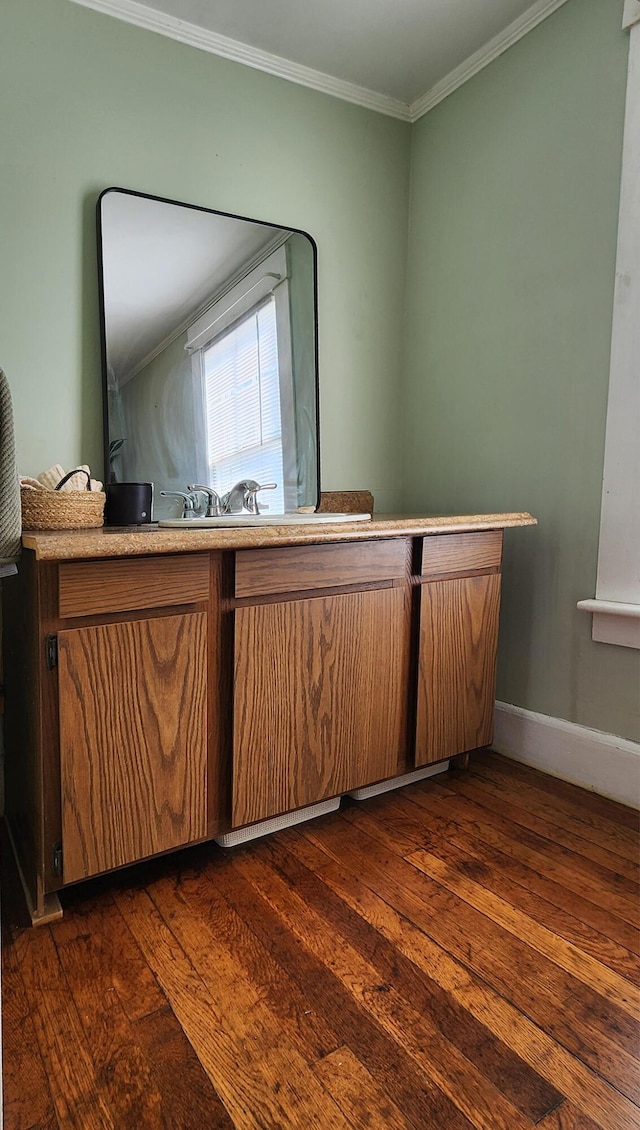 4 Burgess Rd, Guilford, ME 04443 - interior space with dark wood-type flooring, ornamental molding, baseboards, and brown cabinetry
