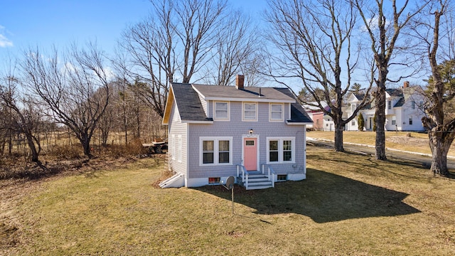 4 Burgess Rd, Guilford, ME 04443 - view of front facade featuring a front lawn, a chimney, entry steps, and roof with shingles