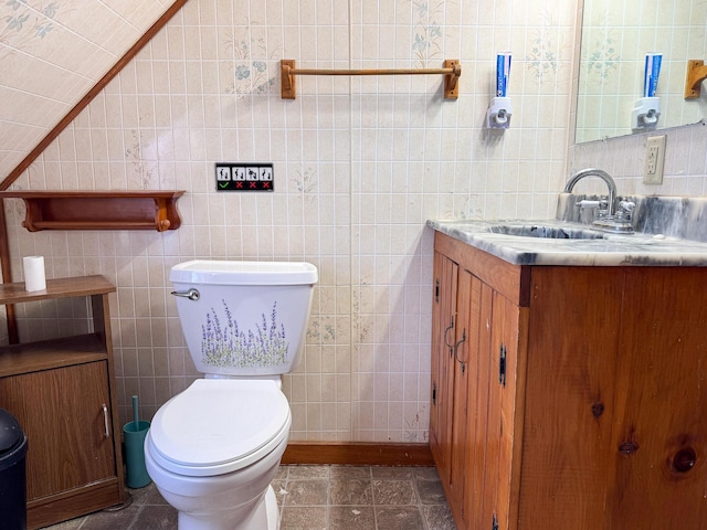 201 Mcburnie Rd, Presque Isle, ME 04769 - bathroom with toilet, tile walls, vanity, and vaulted ceiling
