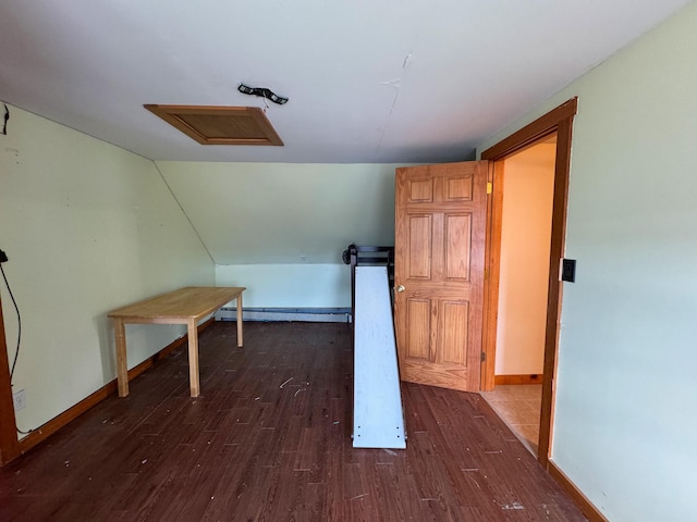 201 Mcburnie Rd, Presque Isle, ME 04769 - additional living space with baseboard heating, dark wood-type flooring, attic access, and baseboards