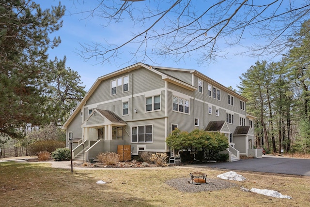51 Woodland Rd Unit 1, Cape Elizabeth, ME 04107 - rear view of house featuring driveway and an outdoor fire pit