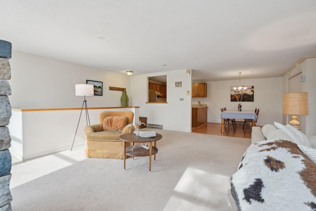 51 Woodland Rd Unit 1, Cape Elizabeth, ME 04107 - living room with a baseboard heating unit, an inviting chandelier, and light carpet