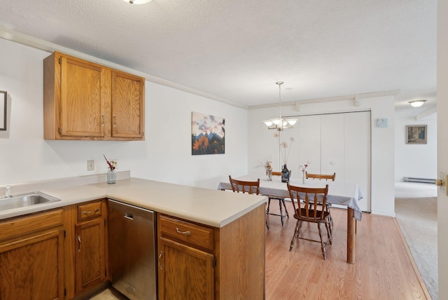 51 Woodland Rd Unit 1, Cape Elizabeth, ME 04107 - kitchen featuring a peninsula, stainless steel dishwasher, light wood-style floors, brown cabinetry, and light countertops