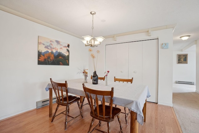 51 Woodland Rd Unit 1, Cape Elizabeth, ME 04107 - dining room with a notable chandelier, baseboards, light wood-style floors, and a baseboard radiator