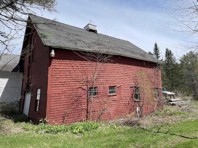 view of property exterior featuring roof with shingles