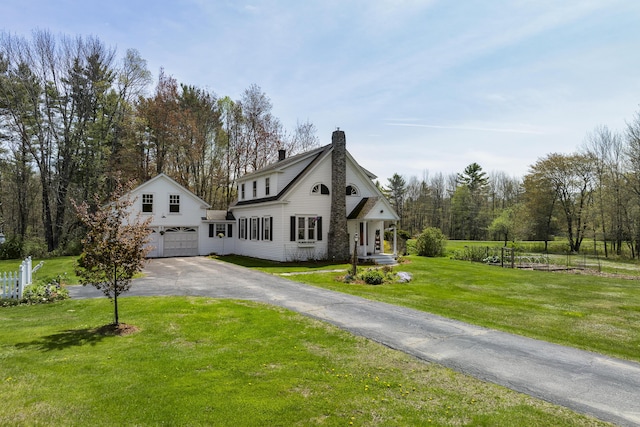 294 E Pond Rd, Jefferson, ME 04348 - view of front of property with asphalt driveway, an attached garage, a chimney, and a front yard