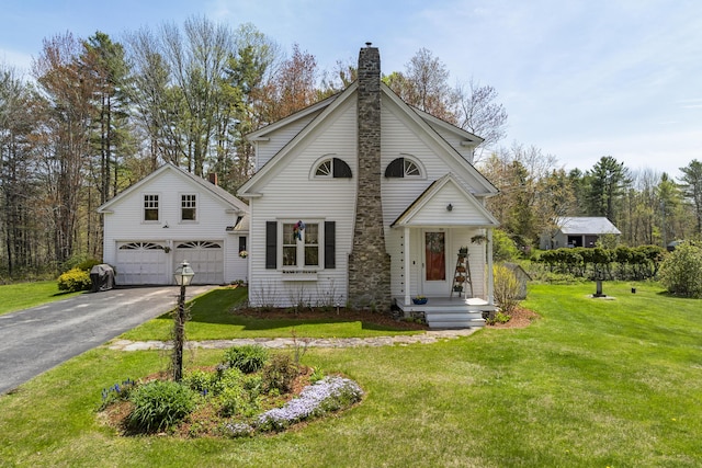 294 E Pond Rd, Jefferson, ME 04348 - view of front of home featuring a chimney, driveway, and a front lawn
