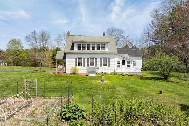 294 E Pond Rd, Jefferson, ME 04348 - back of house with a garden, a yard, and a chimney
