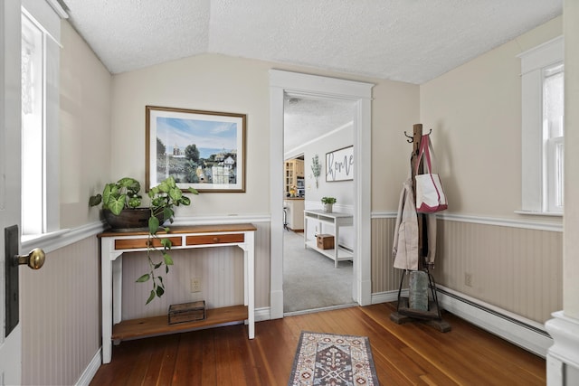 294 E Pond Rd, Jefferson, ME 04348 - hallway with a baseboard radiator, a textured ceiling, hardwood / wood-style flooring, and vaulted ceiling