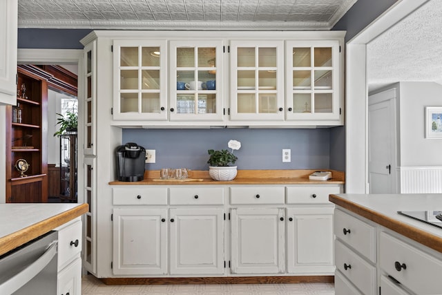 294 E Pond Rd, Jefferson, ME 04348 - kitchen with light countertops, stainless steel dishwasher, glass insert cabinets, white cabinets, and an ornate ceiling