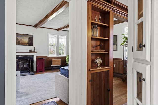 294 E Pond Rd, Jefferson, ME 04348 - hall with a wainscoted wall, a textured ceiling, crown molding, wood finished floors, and beam ceiling