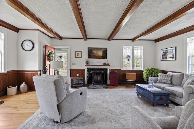 294 E Pond Rd, Jefferson, ME 04348 - living area with wainscoting, wood finished floors, a textured ceiling, plenty of natural light, and wood walls