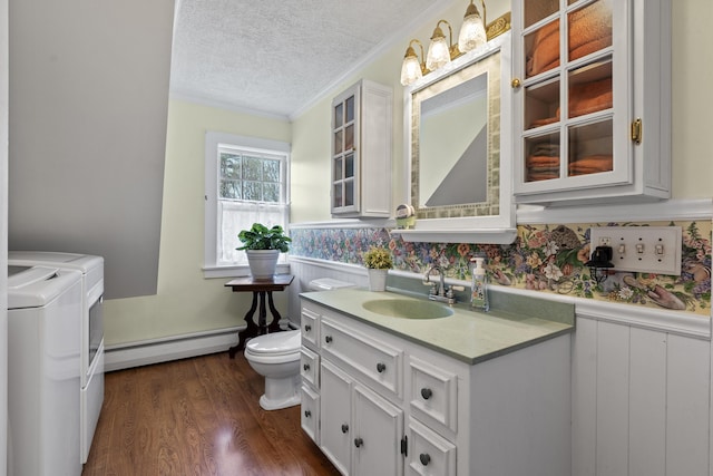 294 E Pond Rd, Jefferson, ME 04348 - bathroom featuring baseboard heating, washer and clothes dryer, a wainscoted wall, a textured ceiling, and toilet