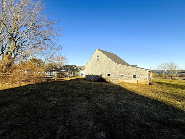 795 Bremen Rd, Waldoboro, ME 04572 - view of side of property with an outdoor structure, fence, and a lawn