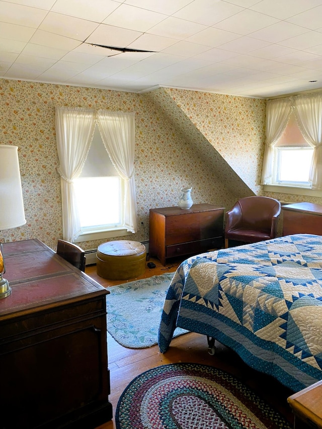 795 Bremen Rd, Waldoboro, ME 04572 - bedroom with a baseboard radiator, wallpapered walls, a baseboard heating unit, and wood finished floors
