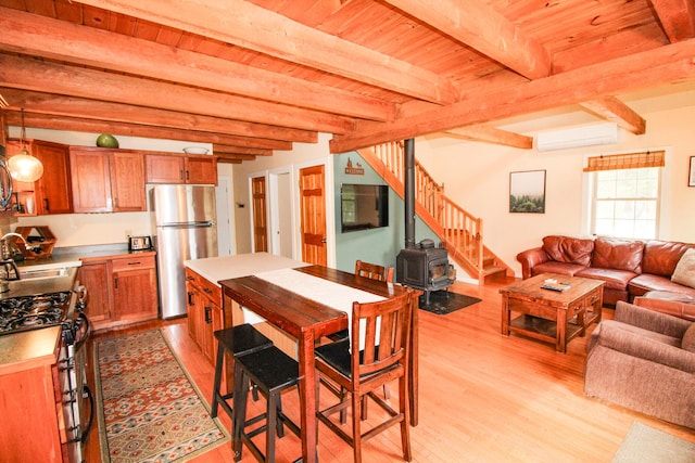4 Bobs Way, Bethel, ME 04217 - dining area with a wall mounted air conditioner, light wood-style floors, wood ceiling, beamed ceiling, and a wood stove