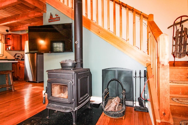 4 Bobs Way, Bethel, ME 04217 - detailed view of a wood stove, wood finished floors, and freestanding refrigerator