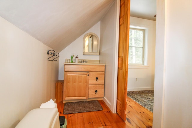 4 Bobs Way, Bethel, ME 04217 - half bathroom with wood-type flooring, toilet, vanity, and lofted ceiling