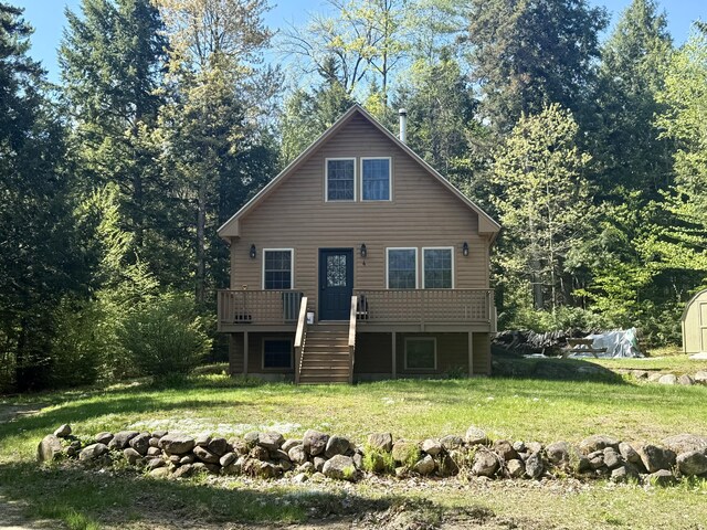 4 Bobs Way, Bethel, ME 04217 - view of front of property with stairs, a deck, a front yard, an outdoor structure, and a storage shed