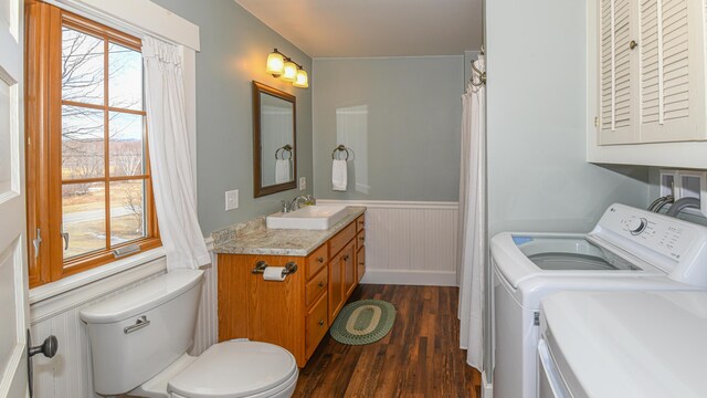 257 S Rumford Rd, Rumford, ME 04276 - full bath featuring washer and dryer, wood finished floors, toilet, a wainscoted wall, and vanity