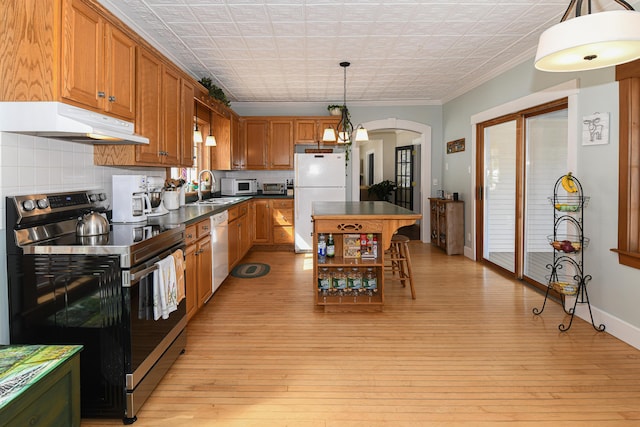 257 S Rumford Rd, Rumford, ME 04276 - kitchen with white appliances, under cabinet range hood, a sink, dark countertops, and ornamental molding