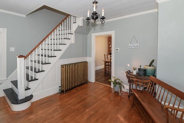 257 S Rumford Rd, Rumford, ME 04276 - staircase with radiator, ornamental molding, hardwood / wood-style floors, and a chandelier