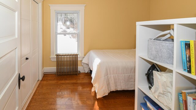 257 S Rumford Rd, Rumford, ME 04276 - bedroom featuring radiator and wood finished floors