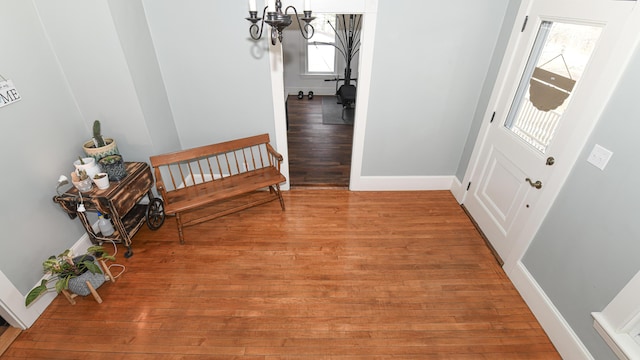 257 S Rumford Rd, Rumford, ME 04276 - hallway featuring light wood-style flooring, a chandelier, and baseboards