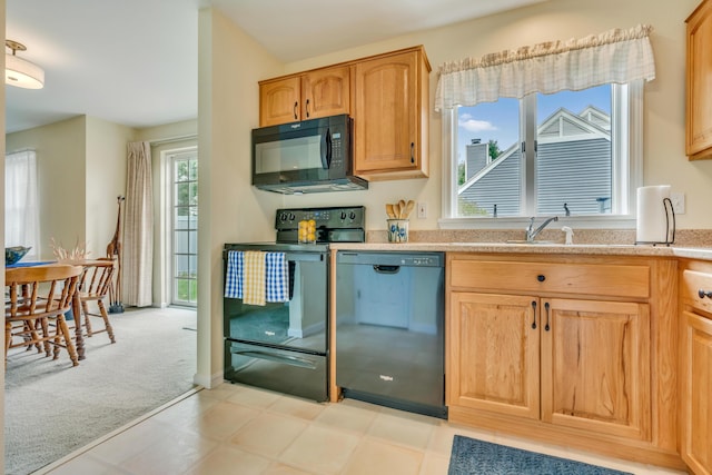 23 Winterberry Ct Unit 23, Cumberland, ME 04021 - kitchen with a sink, light floors, light stone counters, black appliances, and light carpet