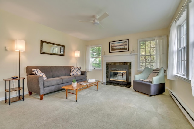 23 Winterberry Ct Unit 23, Cumberland, ME 04021 - carpeted living area with a baseboard heating unit, a wealth of natural light, a premium fireplace, and a ceiling fan