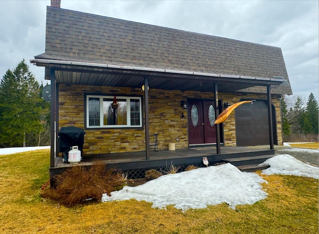 4197 Aroostook Rd, Winterville Plt, ME 04739 - view of front of home featuring a porch, roof with shingles, a chimney, and stone siding
