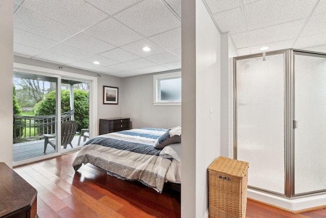 1081 Kings Hwy, Kennebunkport, ME 04046 - bedroom with access to exterior, wood finished floors, multiple windows, a paneled ceiling, and recessed lighting