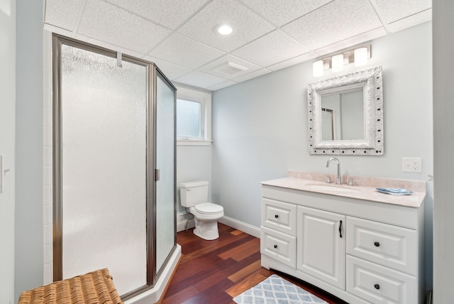 1081 Kings Hwy, Kennebunkport, ME 04046 - bathroom with wood finished floors, vanity, a stall shower, toilet, and a drop ceiling