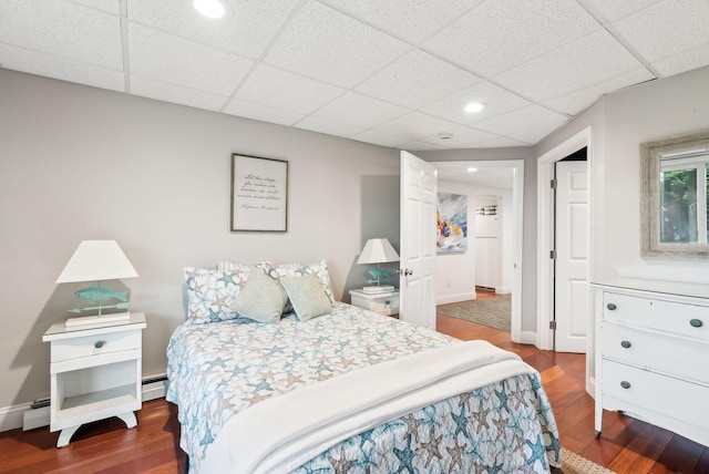1081 Kings Hwy, Kennebunkport, ME 04046 - bedroom featuring wood finished floors, a paneled ceiling, recessed lighting, baseboards, and a baseboard radiator